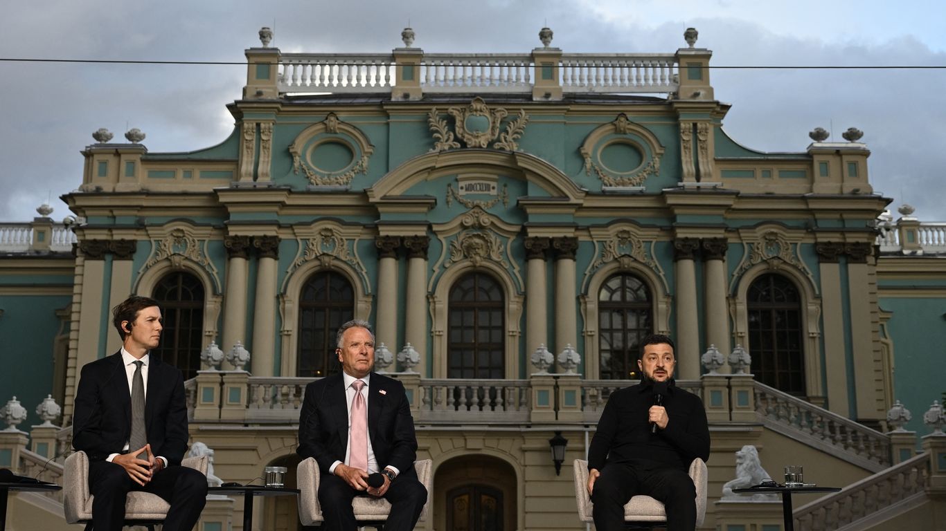 Kushner, Witkoff, and a seated speaker appear onstage before an ornate blue-and-cream building.